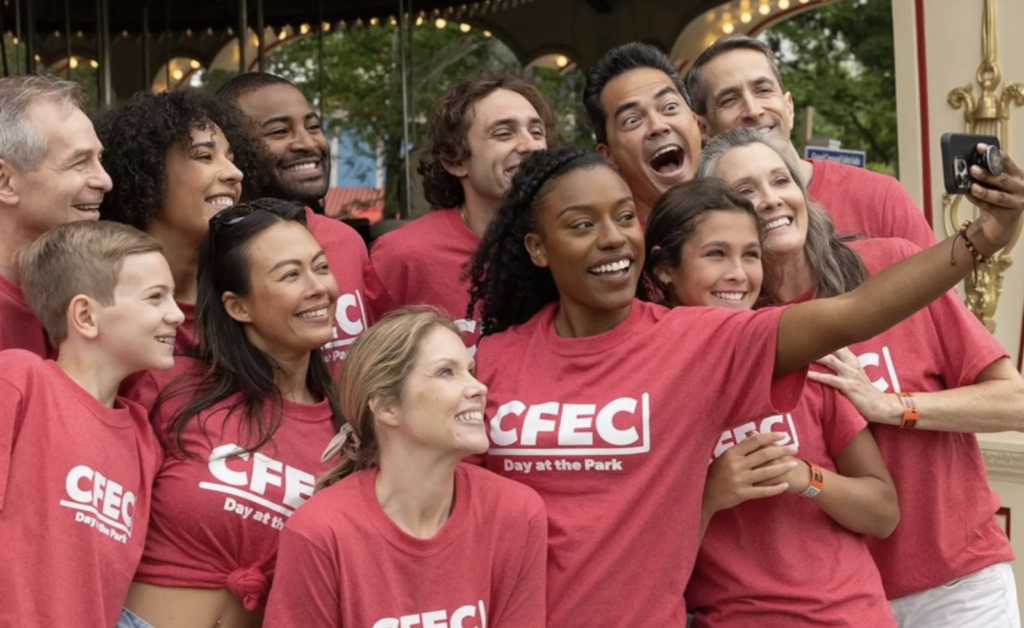 Team members don matching shirts and pose at Six Flags