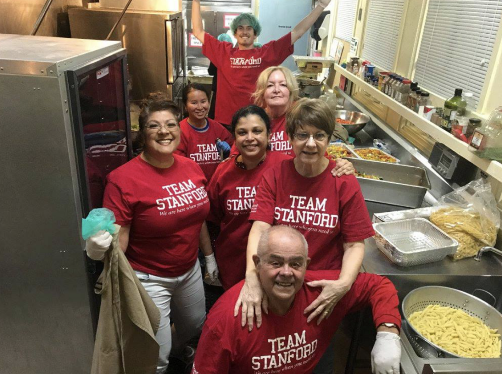 Team members help feed the community in the Community Seva Kitchen