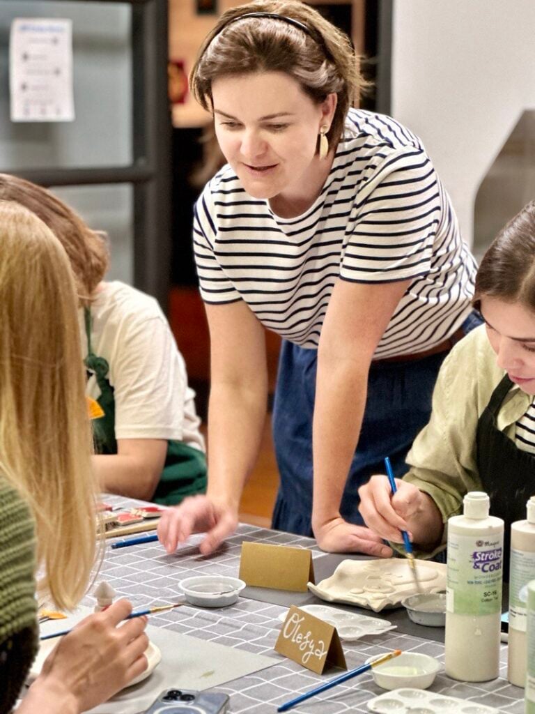 A teacher directs those new pottery