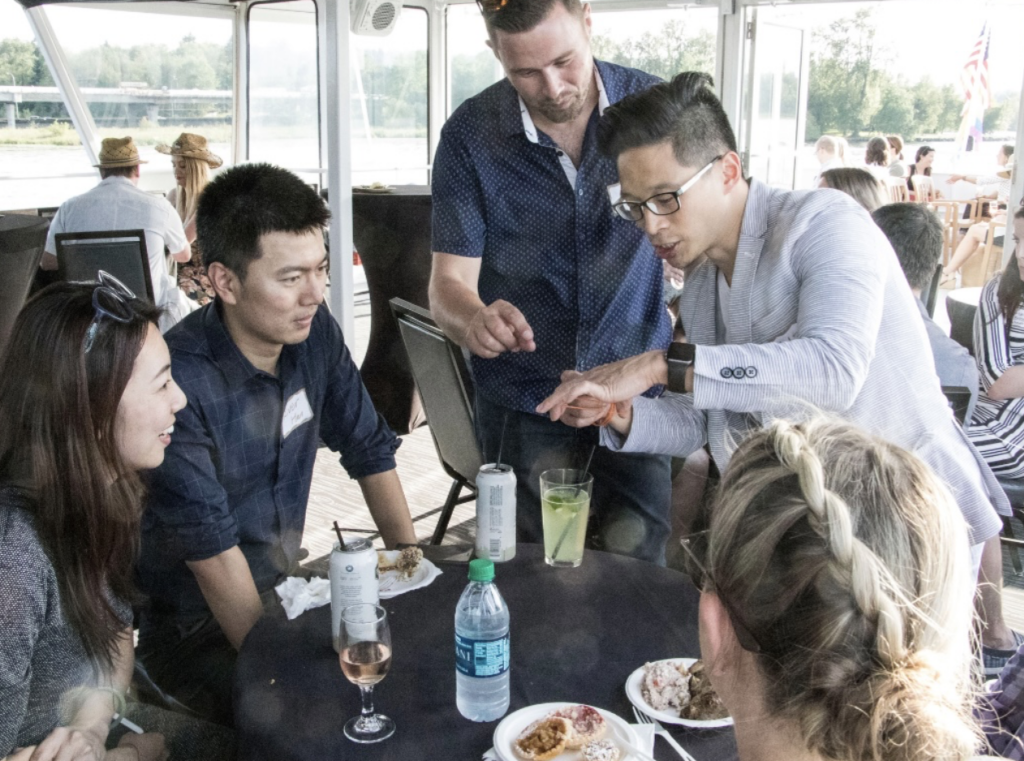 Team members chat around a table of drinks on an Argosy Cruise ship