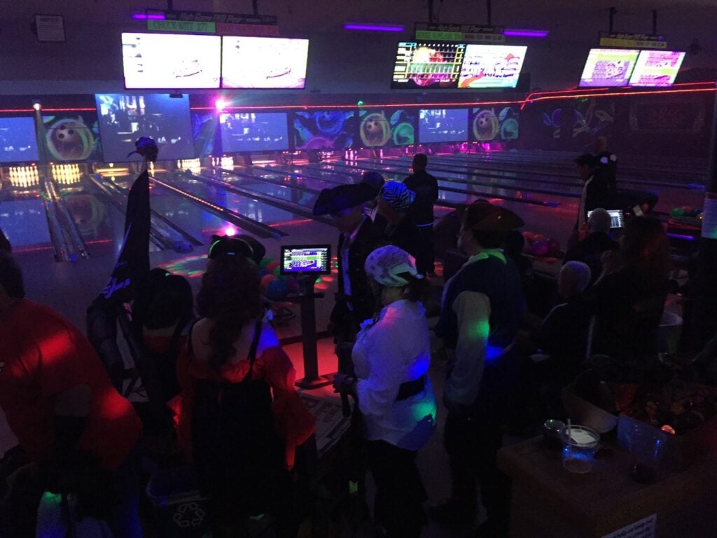 The lights are dim with lasers lighting the bowling alley at Bel Mateo Bowl