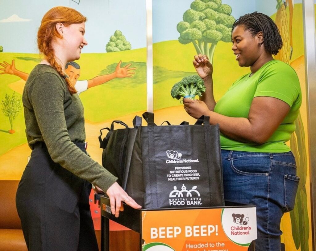 Volunteers look at produce at the Capital Area Food Bank