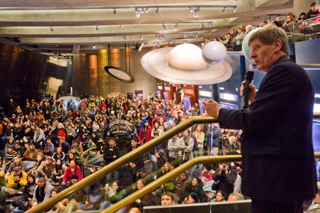 A lecturer speaks to a full auditorium at the Griffith Observatory