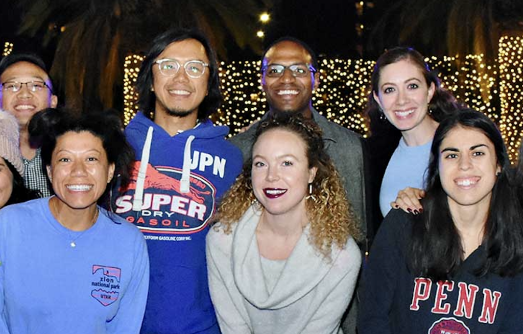 Team members pose outside of the Holiday ice rink in Los Angeles