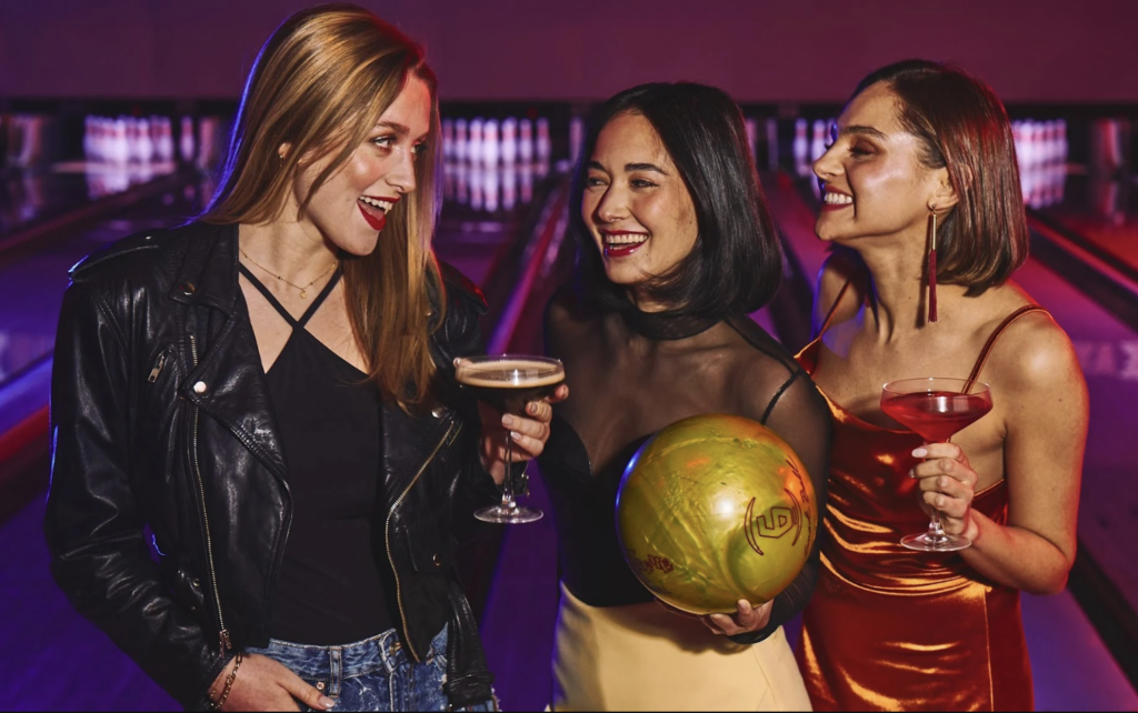 Team members cheers between rounds of bowling at Lucky Strike