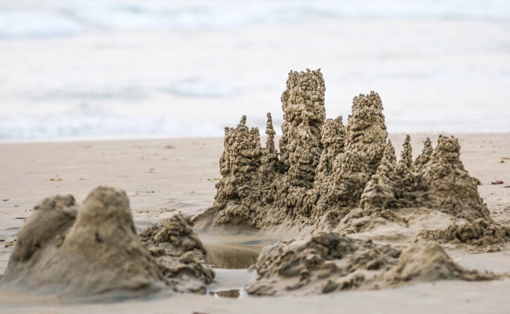 Sand castles are created on a scenic beach