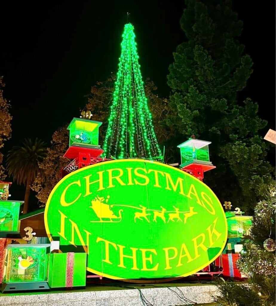 The neon green sign advertises christmas in the park San Jose
