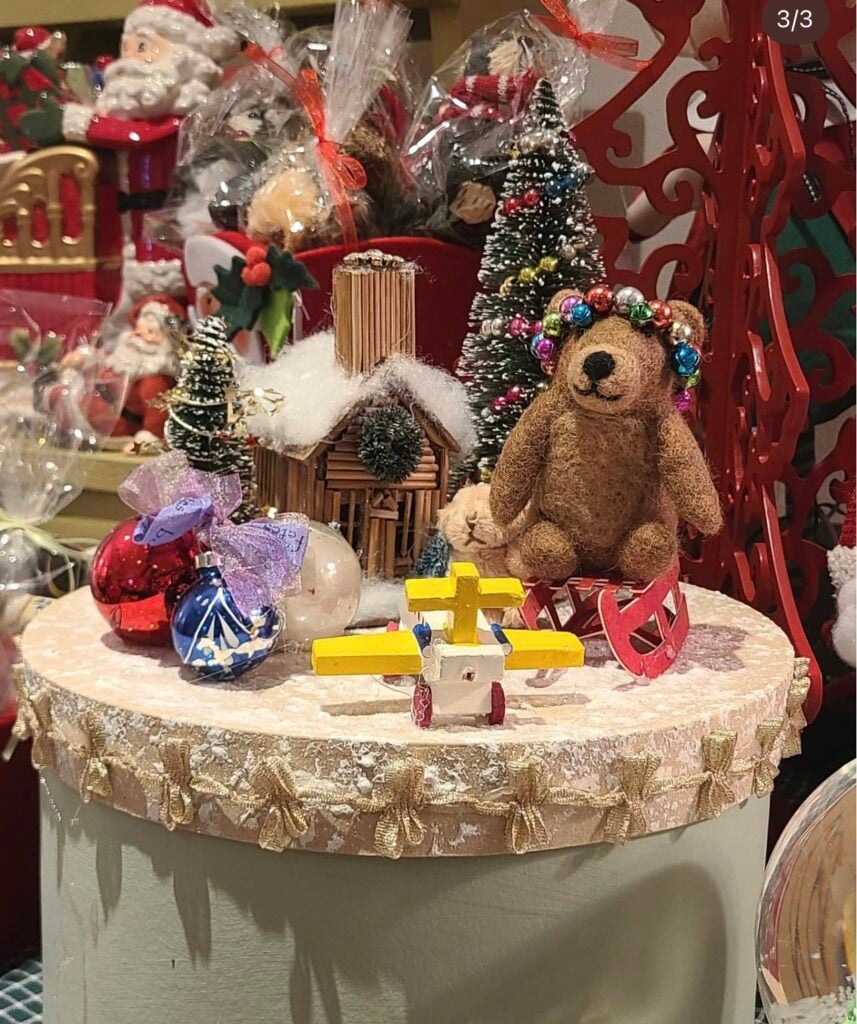 a bear and christmas ornaments sit on a table