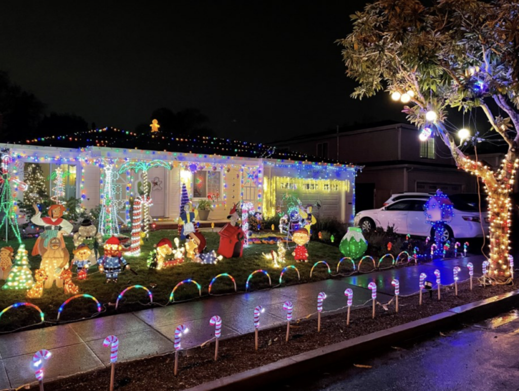 sparkly christmas lights cover the exterior of a redwood city house