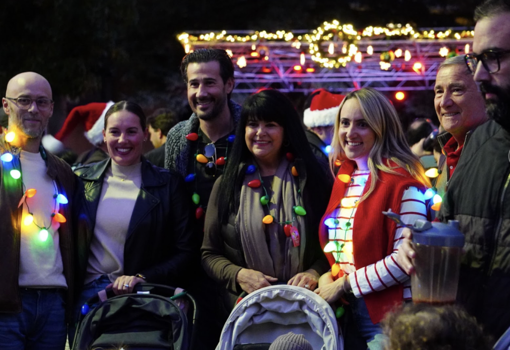 four friends pose in holiday clothing
