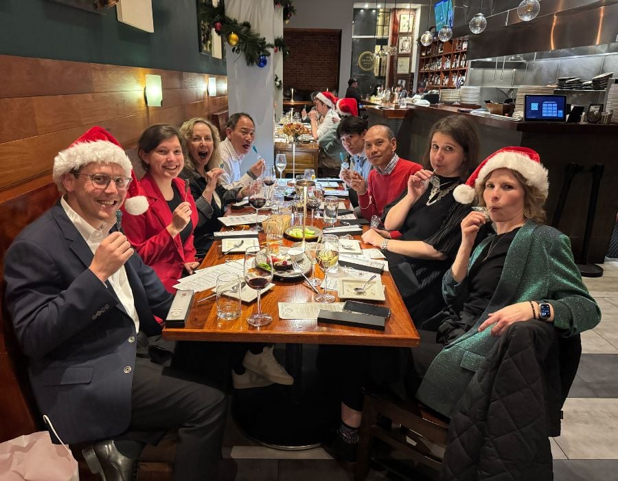 group posting at table during corporate holiday party