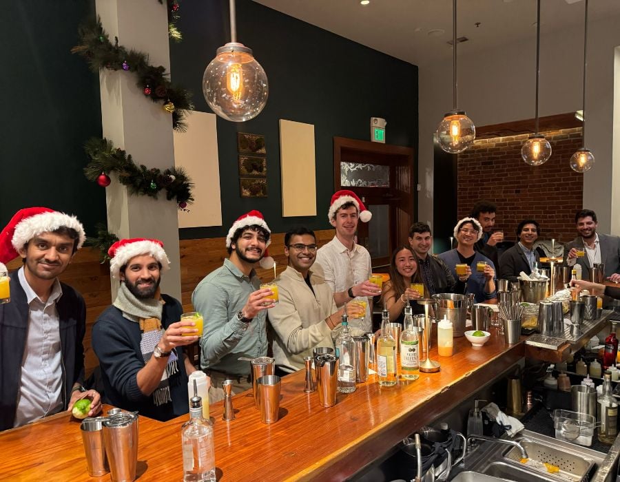 group toasting cocktails during company holiday party