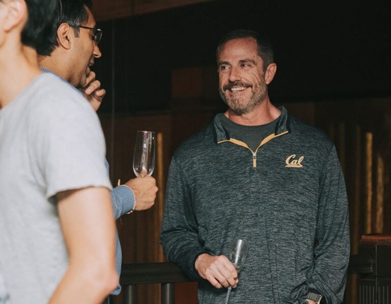 man smiling during interactive mingling hour