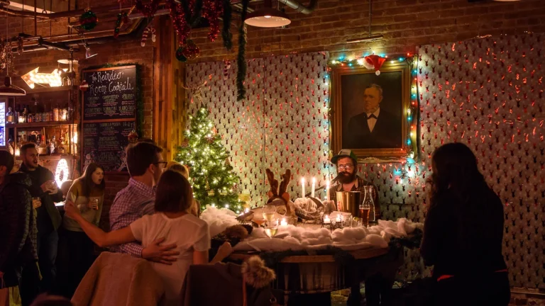 Couples watch a pianist play at qa christmas themed bar