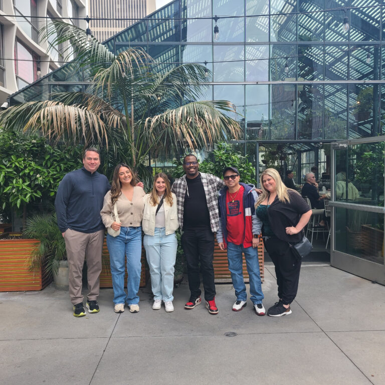 group standing outside a restaurant in koreatown during team building food tour