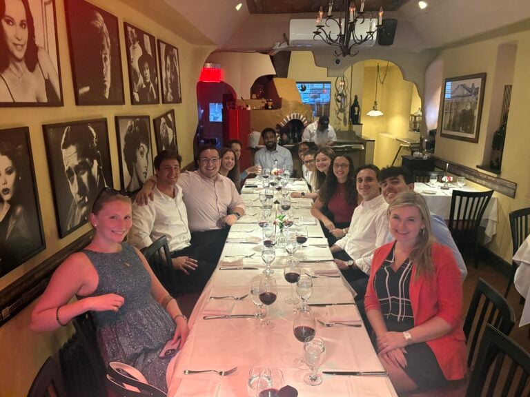 group smiling at table during nyc team building food tour