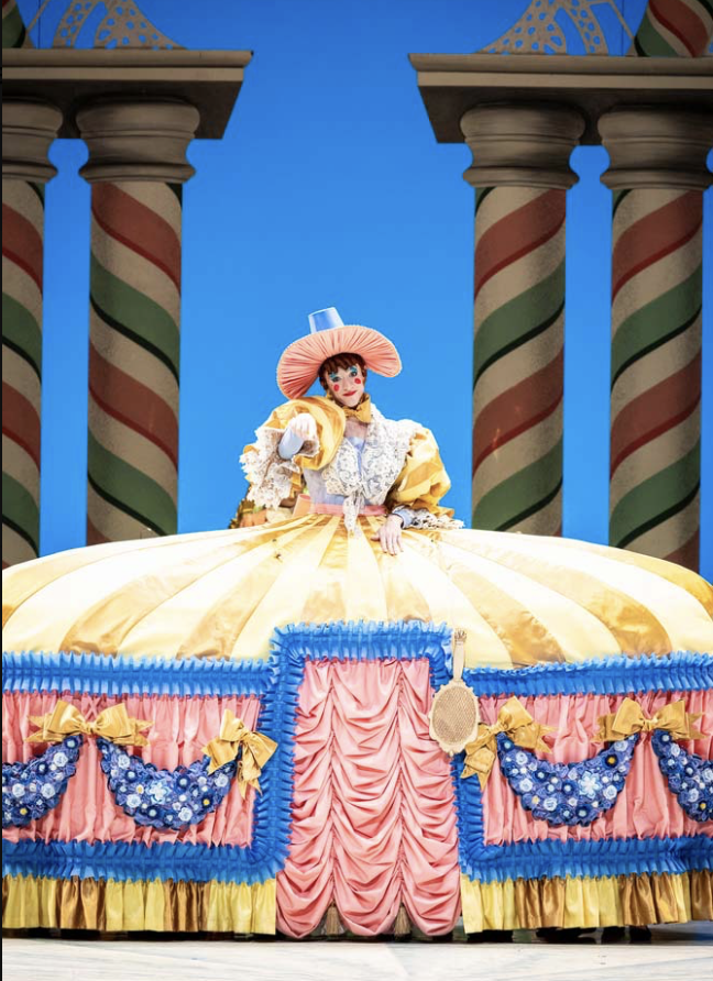 A woman in a big yellow striped dress performs in the Nutcracker