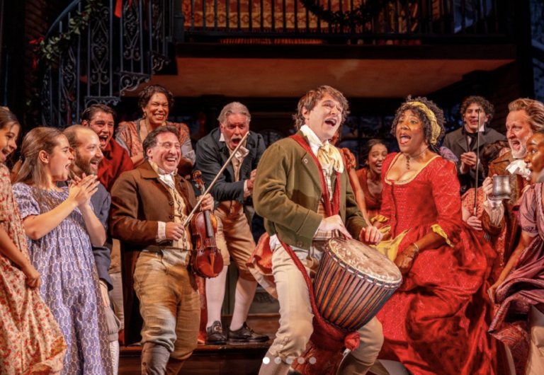 The cast of the christmas carol dances and plays instruments