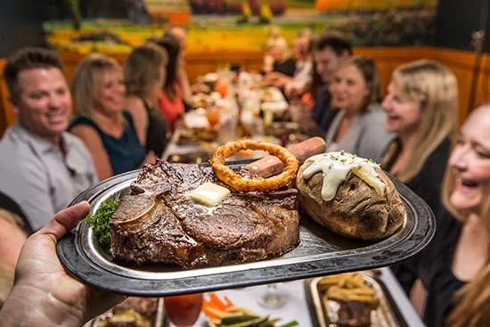 large steak being served to a banquet during portland corporate holiday party