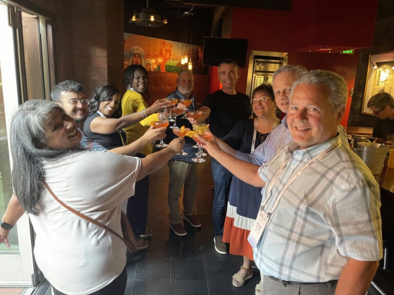 group toasting cocktails during denver happy hour event with avital