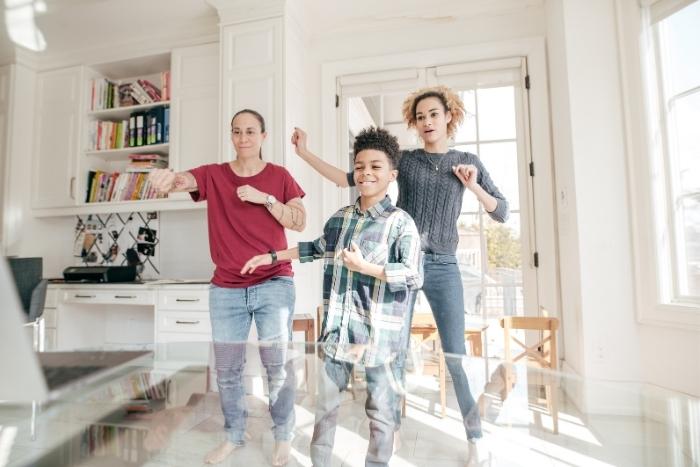 family dancing during virtual happy hour event