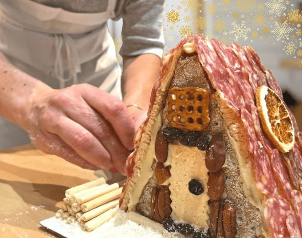 Person building charcuterie chalet